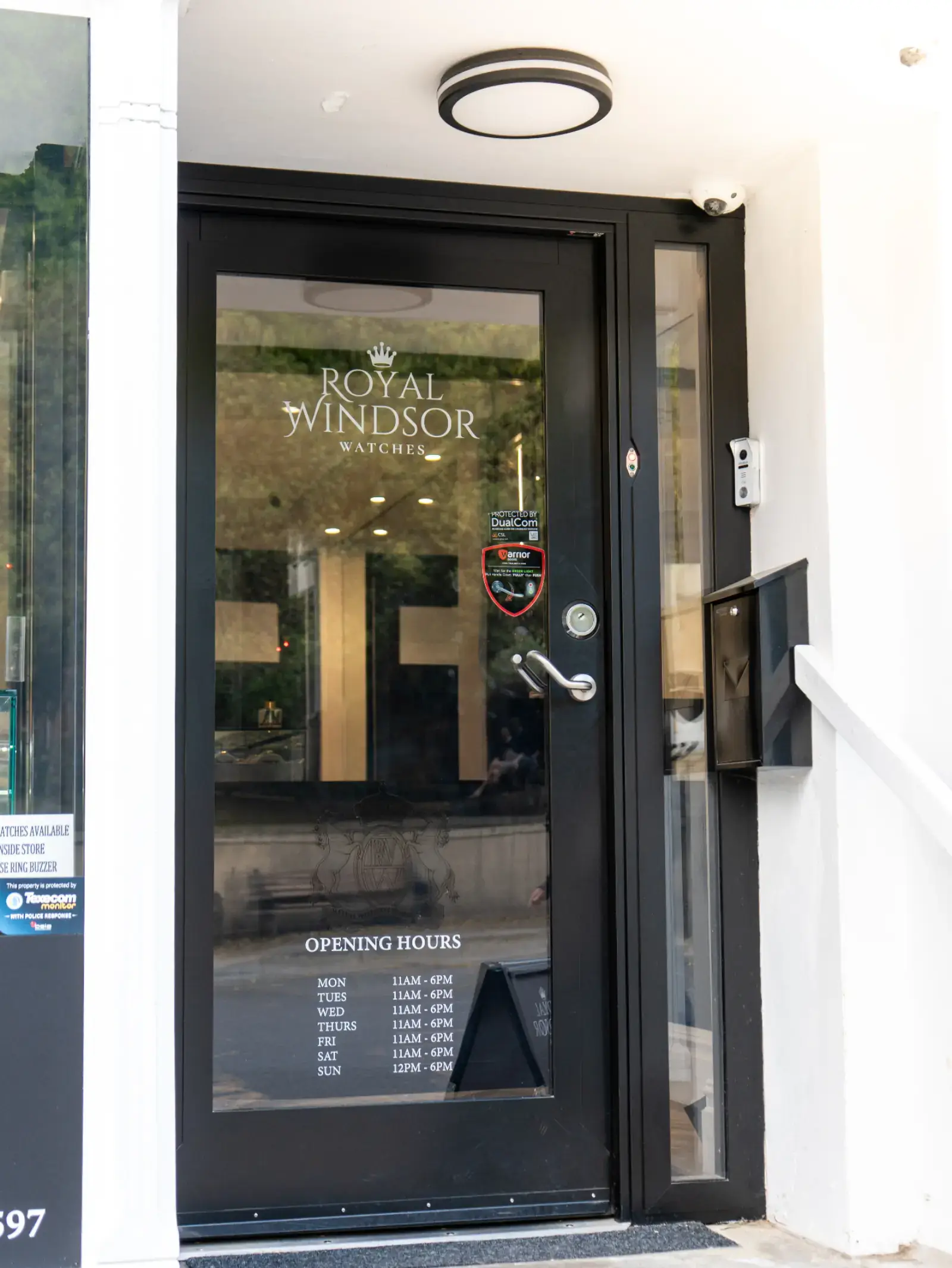 Showroom entrance door with opening hours